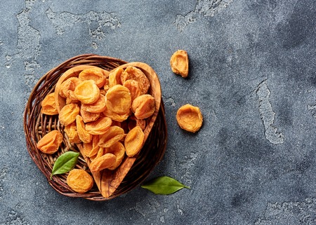 Dried apricots on gray concrete background with copy space. Top view.の写真素材