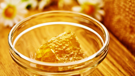 Honeycomb in glass bowl. Close-up of honey. Healthy organic.の写真素材