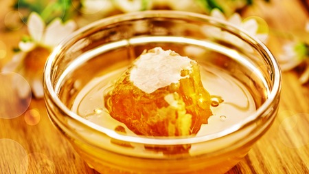 Honeycomb in glass bowl. Close-up of honey. Healthy organic.の写真素材
