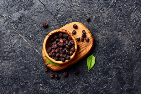 Dried hawthorn fruits on black background. Top view of Crataegi fructus.の写真素材