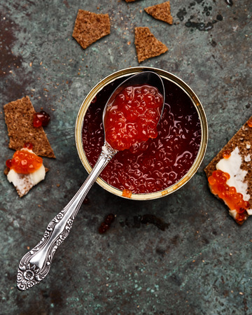 red caviar int tin with crispbreads and butterの写真素材