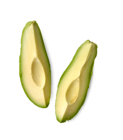 Avocado slices isolated on a white backgroundの写真素材