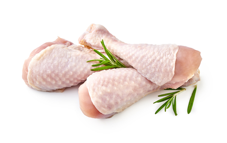 Raw chicken legs with rosemary isolated on white backgroundの写真素材
