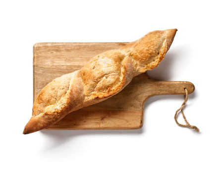 German baguette on wooden board isolated. Top view or french bread. Bakery.の写真素材