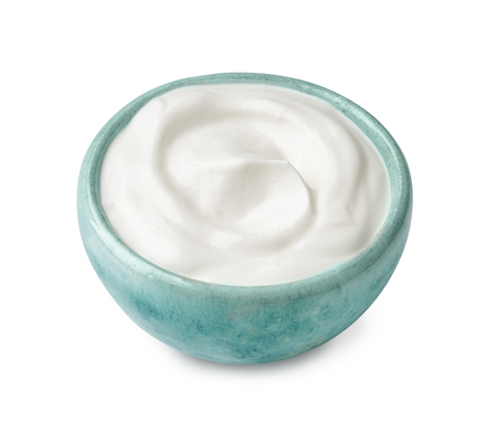 Blue bowl of sour cream yogurt isolated on white backgroundの写真素材