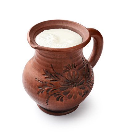 Milk in clay jug isolated on white backgroundの写真素材