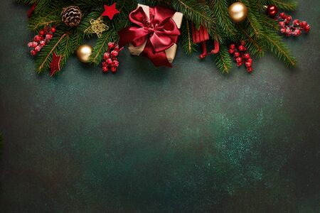 Xmas presents with decoration and fir branches on green background.の写真素材