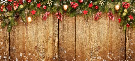 Christmas wooden banner with decoration and fir tree. Snow and light. View with copy space.の写真素材