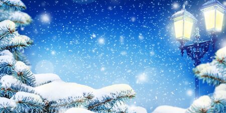 Winter Christmas Night background with snow, snow drifts, lamps and snowfall. Dark blue background with copy space.の写真素材