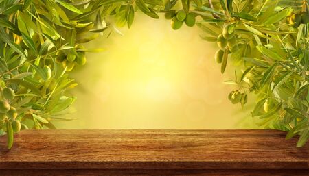 Mockup of empty table with olives branches with fresh olives on yellow background.の写真素材