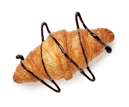 Fresh croissant with chocolate sauce on a white background. Top view.の写真素材