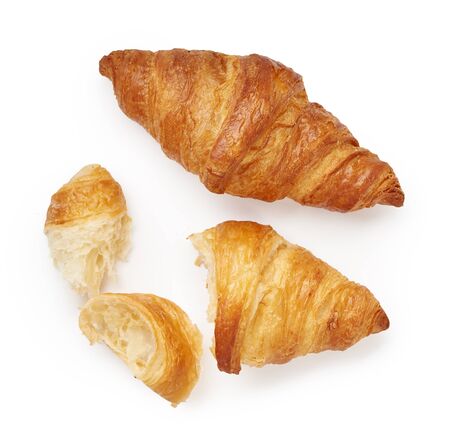 Two croissants with crumbs isolated on white backgroundの写真素材