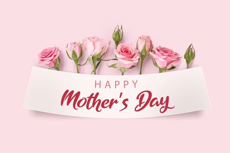 Mother's day greeting card with blossom flowers. Rose flowers on pink background. Studio shot of pink rosebuds. Happy Mothers Day.の写真素材