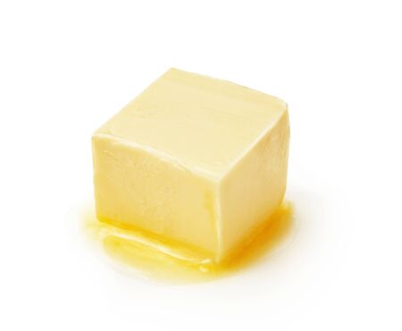 A piece of melting butter isolated on white background. Butter cube.の写真素材