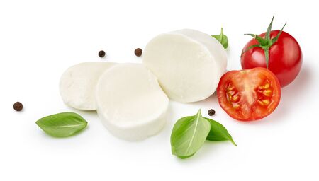 Pieces of mozzarella Buffalo cheese with tomatoes. Sliced cheese with black peppers and basil leaves isolated on white background.の写真素材