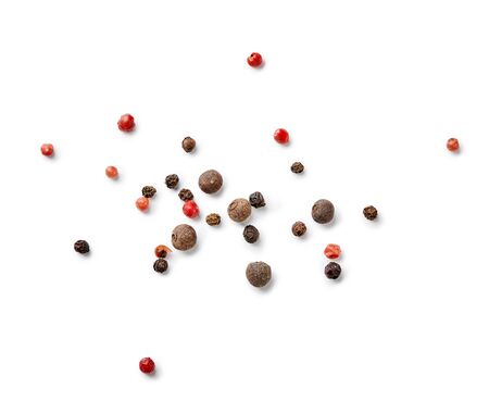 Mix of black and red pepper, pimento isolated on white background. Top view of allspices and spices.の写真素材
