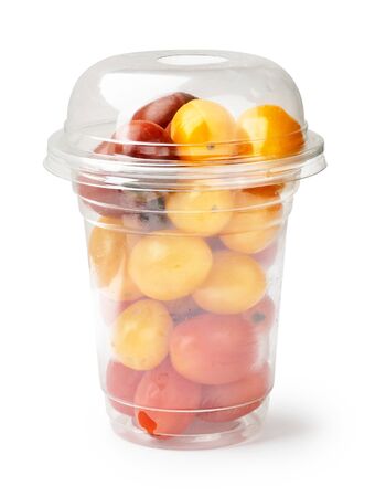 Cherry red tomatoes and yellow tomatoes in plastic packaging on the white background.の写真素材