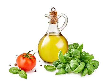 Glass jar of olive or vegetable oil with basil leaves and tomato isolated on white.の写真素材