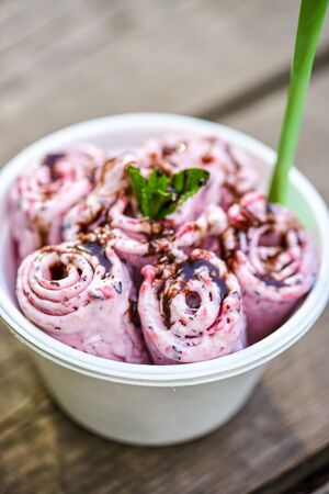 Berry ice cream with mint leaf on gray wooden backgroundの写真素材