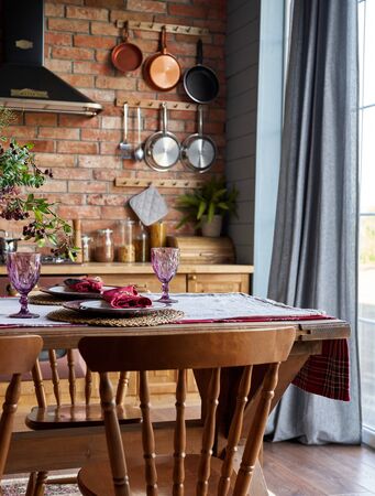 Serving for dinner on kitchen table. Warm kitchen background interior.の写真素材