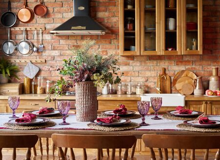 Serving for dinner on kitchen table. Warm kitchen background interior.の写真素材