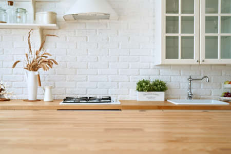 Kitchen wooden table top and kitchen blur background interior style scandinavianの写真素材