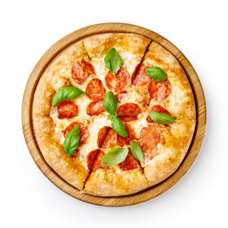 Pepperoni pizza with basil leaves on wooden board isolated. Top view of sliced pizza.の写真素材