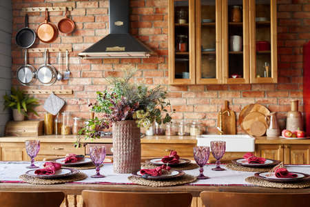 Serving for dinner on kitchen table. Warm kitchen background interior.の写真素材