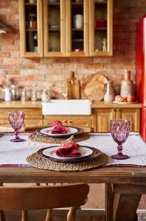 Serving for dinner on kitchen table. Warm kitchen background interior.の写真素材