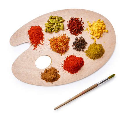 Set of spices on wooden board. Top view of palette with colorful spices isolated on white background.の写真素材