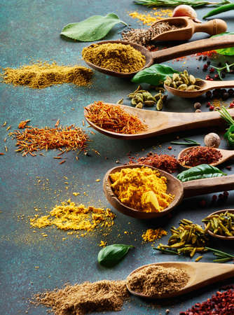 Various spice and dried herbs on dark green background.の写真素材