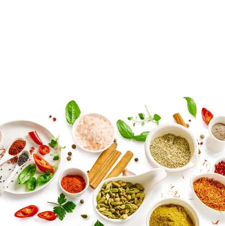 Different indian spices in a bowls and herbs on white background. Top view of indian spices with copy space.の写真素材