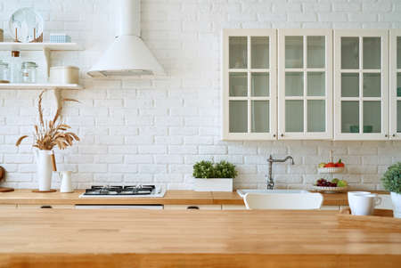 Kitchen wooden table top and kitchen blur background interior style scandinavianの写真素材