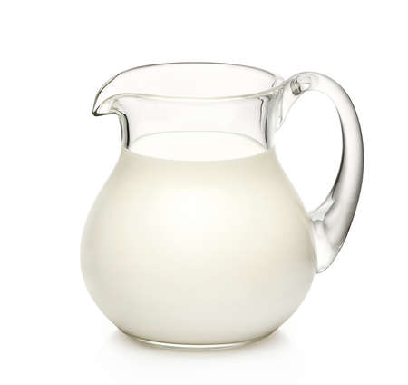 Glass jug of milk isolated on white backgroundの写真素材