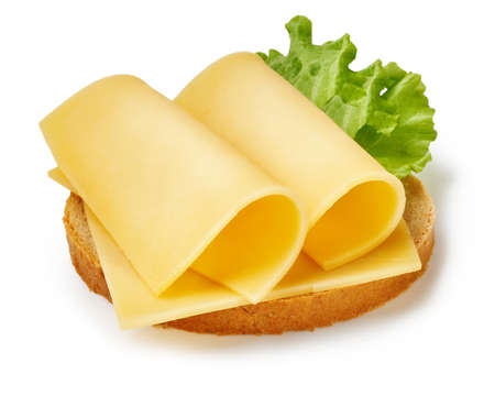 Cheese slices with salad leaf on piece of bread. Sandwich isolated on white background.の写真素材
