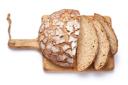 Sliced bread on wooden cutting board isolated on white background. Top view.の写真素材