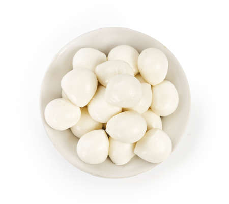 Fresh Mozzarella balls in white bowl isolated on white. Top view.の写真素材