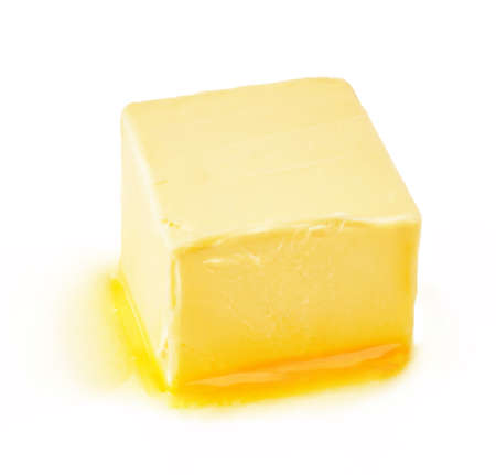 A piece of melting butter isolated on white background. Butter cube.の写真素材