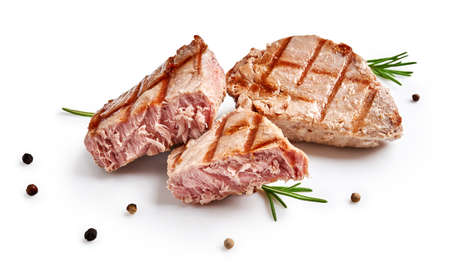 Two grilled tuna steak with rosemary and spices isolated on white. Tuna fish slices with herbs.の写真素材