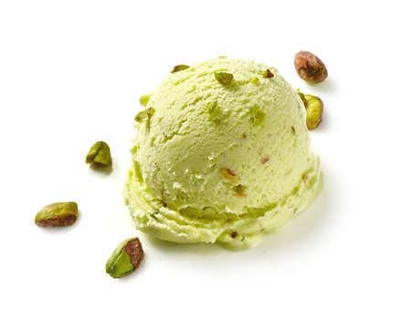 Scoop of pistachio ice cream with pistachio nuts on white background. Ice cream isolated for package design of pistachio ice cream.の写真素材