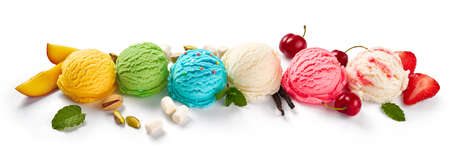 Assorted of ice cream scoops on white background. Colorful set of ice cream scoops of different flavours. Ice cream isolated with nuts, vanilla, mint, fruits and berries.の写真素材