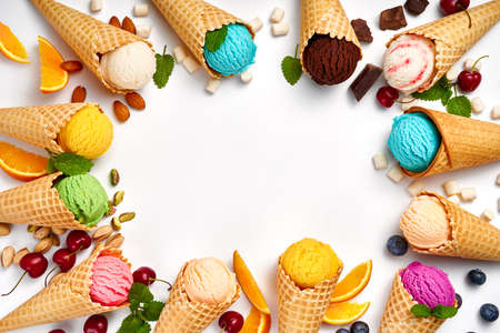 Assorted of ice cream in cones on white background. Colorful set of ice cream of different flavours. Ice cream isolated with nuts, fruits and berries.の写真素材