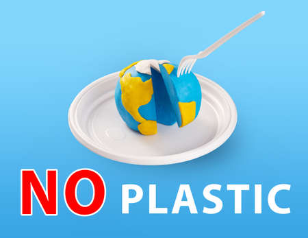 WorldEarth Day concept. Plastic free concept. Pollution problem concept. A plastic plug stuck into...