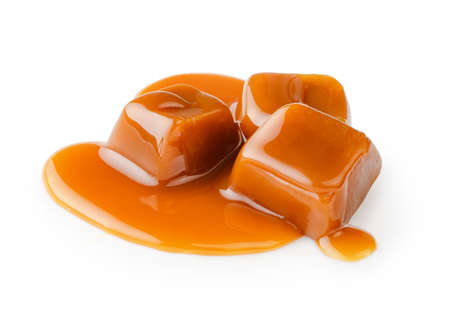 Caramel cubes with caramel sauce isolated on white background.の写真素材