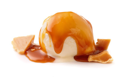 Ice cream ball with caramel cubes and caramel sauce on white. Ice cream isolated.の写真素材