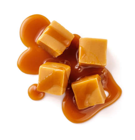 Caramel cubes with caramel sauce isolated on white background. Top view of caramel cubesの写真素材