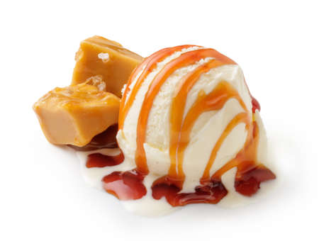 Ice cream ball with caramel cubes and caramel sauce on white. Ice cream isolated.の写真素材