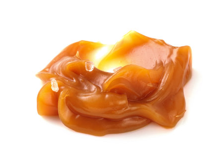 Soft caramel swirl with salt isolated on white background. Caramel sauce.の写真素材