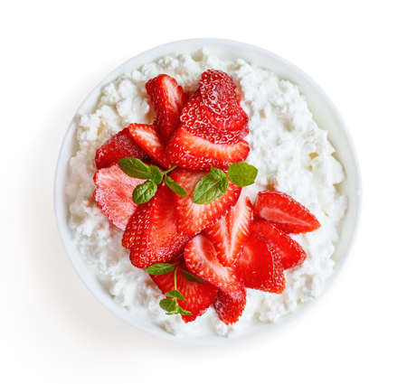 Top view of soft cheese with strawberries in white bowl isolated on white.の写真素材
