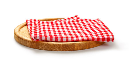 Red check napkin and board for pizza on white background. Red napkin on wooden round board isolated.の写真素材